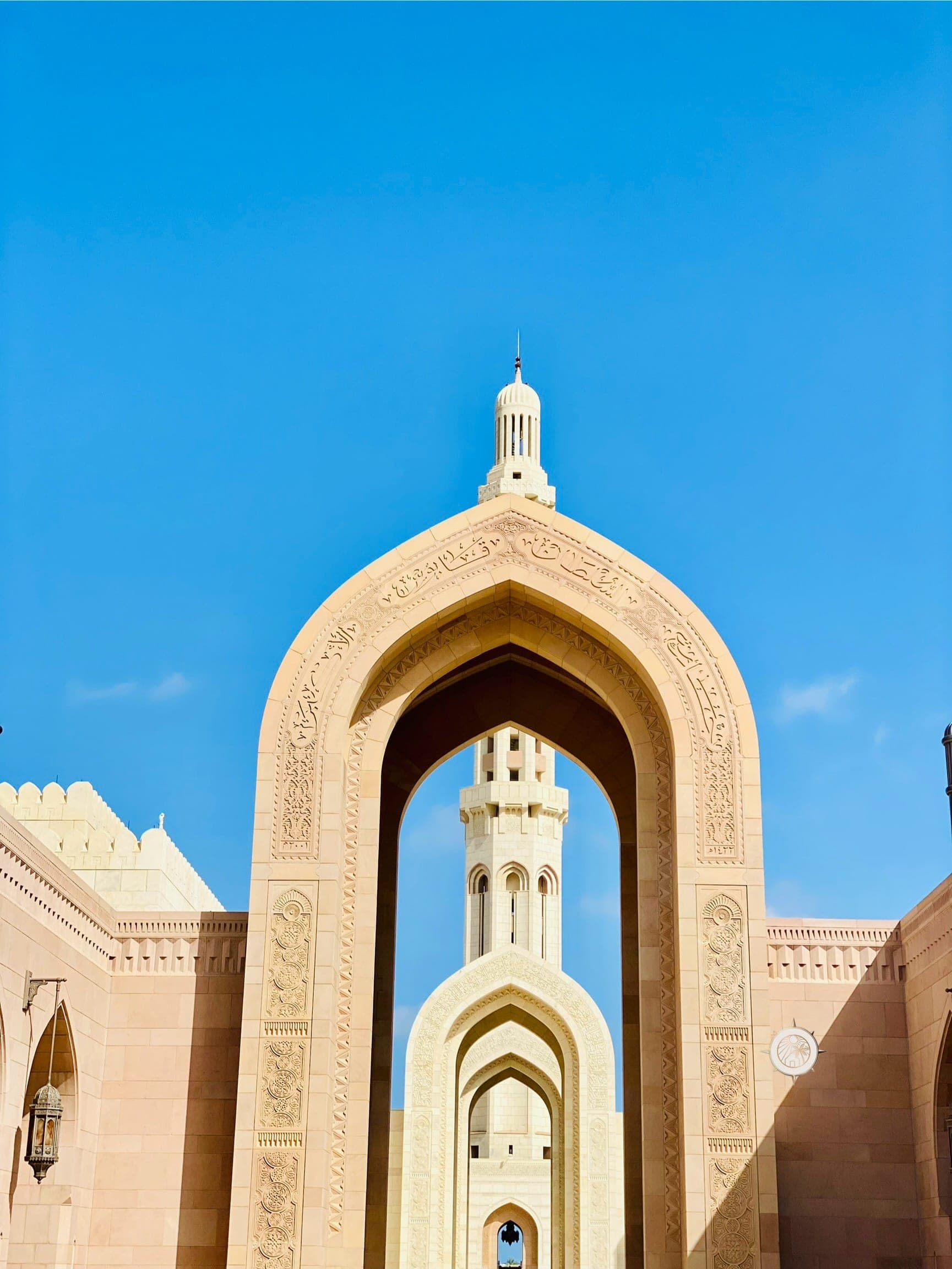 Entrance arch and minaret of the Sultan Qaboos Grand Mosque